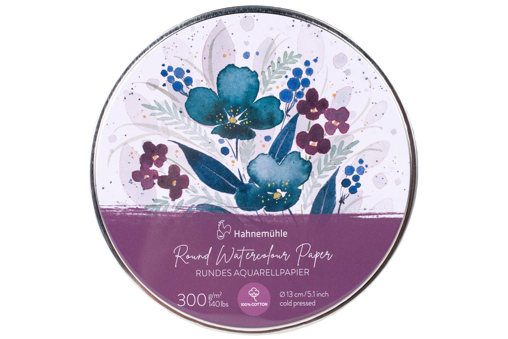 A round tin of Hahnemühle Round Watercolour Paper, featuring a floral watercolor design in blue, purple, and green on a white background with a purple band at the bottom.