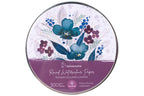 A round tin of Hahnemühle Round Watercolour Paper, featuring a floral watercolor design in blue, purple, and green on a white background with a purple band at the bottom.